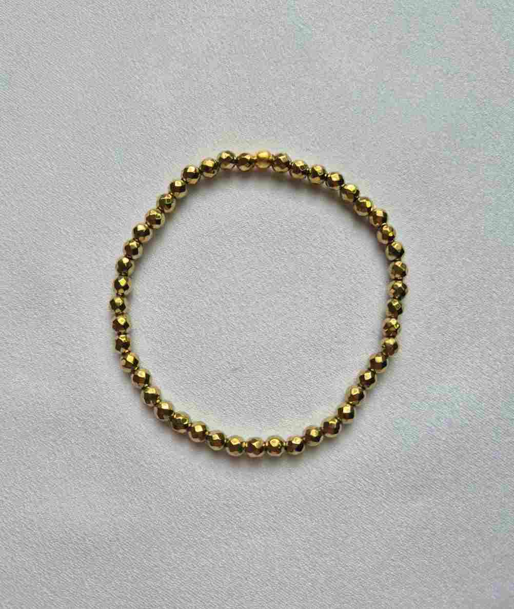 Pulseira hematitas facetadas douradas